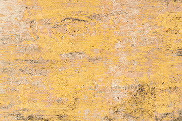 Old weathered yellow wall with rough texture and dirt. Rustic background