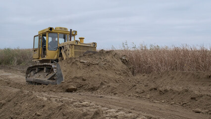 Bul'dozer removes dam in the delta Danube river. Close up
