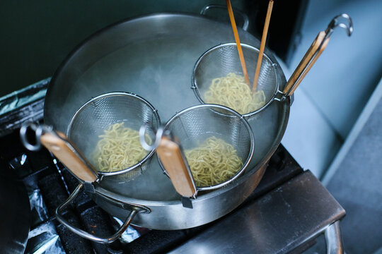 Stock Photo Of Casserole With Boiling Water Cooking Noodles.