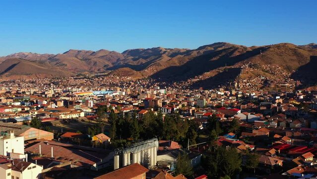 Aerial Forward Beautiful Shot Of Residential Buildings In City By Mountains - Cusco, Peru