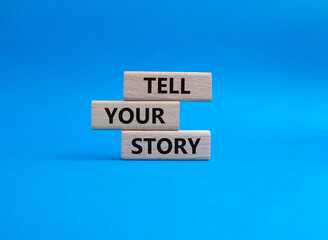 Tell your story symbol. Wooden blocks with words Tell your story. Beautiful blue background. Business and Tell your story concept. Copy space.