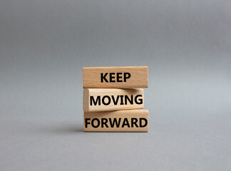 Keep moving forward symbol. Concept words keep moving forward on wooden blocks. Beautiful grey background. Business and keep moving forward concept. Copy space.