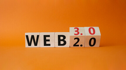 Web 3.0 vs Web 2.0 symbol. Turned cubes with the words web 3.0 and web 2.0. Beautiful orange background. Businessman hand. Business concept. Copy space