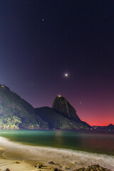 Planetary alignment at dawn on the red beach of Urca in Rio de Janeiro, Brazil