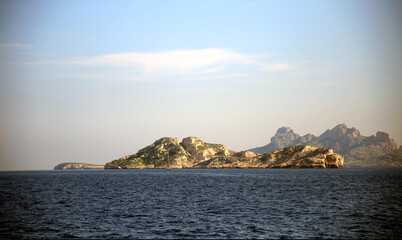 View on the jagged islands, in the distance, over the sea, against the clear sky, Parc National des Calanques, Marseille, France