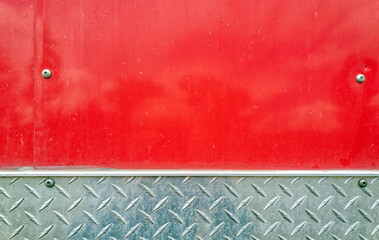 The red metal and diamond plates on the side of a horse trailer