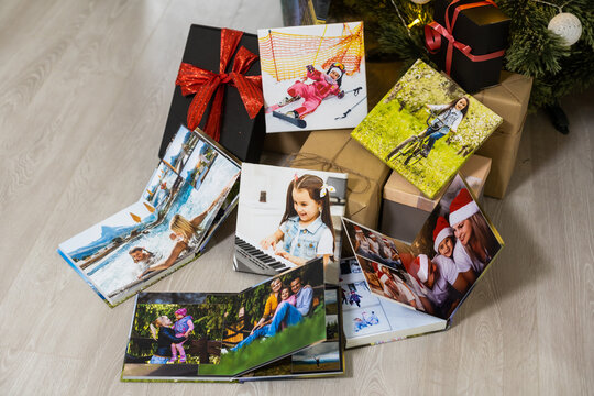 photo canvas and photo books near the christmas tree as a gift