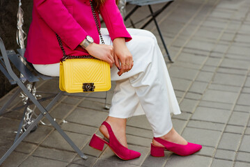 Summer fashion details of elegant female outfit with classic yellow leather bag, wrist watch, white...