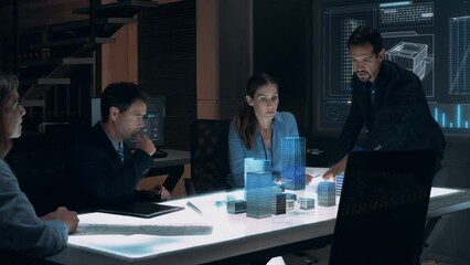 Businessman in Suit presenting Architecture Project to Colleagues and Partners sitting around Futuristic Table with Holographic Modern Augmented Reality Technology.