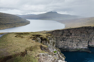 View on the lake Sorvagsvatn in Faroe Islands from the cliffs Traelanípa