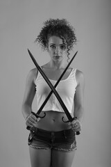 Young curly woman with old swords