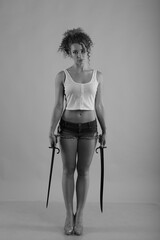 Young curly woman with old swords