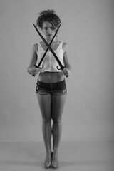 Young curly woman with old swords