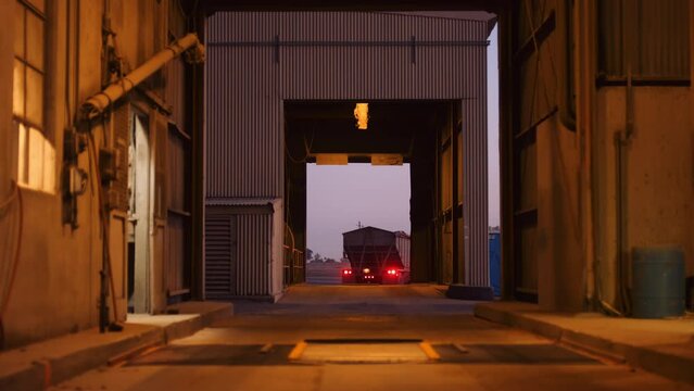 18 wheeler grain semi truck exits silo loading area