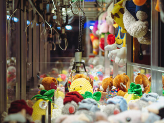 Claw Machines Toy Arcade game with stuffed animal toys on carnival. Entertainment for children in...