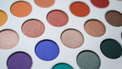 Selective focus of eyeshadow palette with various colors in pearly and matte closeup