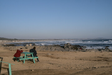 personas de edad madura en la playa tomando fotos