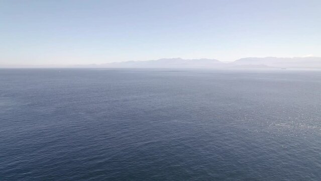 Aerial footage of ocean view near Sooke, Vancouver Island, sunny day, sea, boats, seaside. 5.4K TO 4K 24FPS