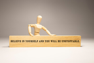 Believe in yourself and you will be unstoppable wooden surface written. Motivation and personal development.