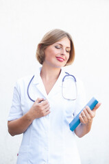 Young beautiful caucasian woman doctor with a phonendoscope on her neck 
