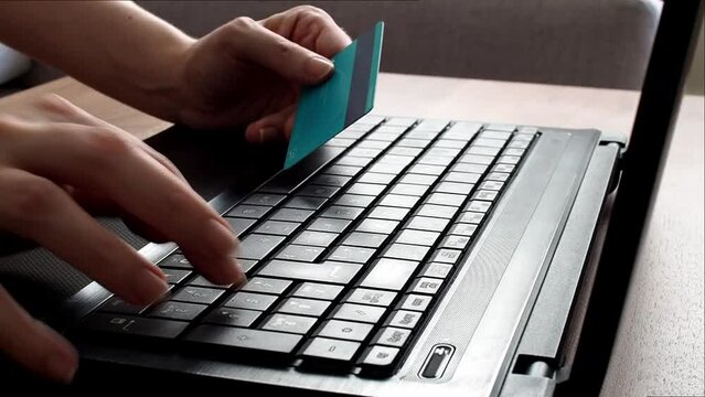 Unrecognizable woman using credit card to buy Online