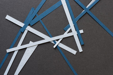 random paper lines on dark gray board