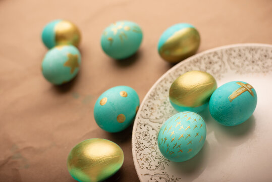 Teal And Gold Dyed Easter Eggs On Vintage Plate And Craft Paper Backdrop