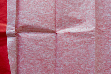 verso side of red tissue paper viewed from top