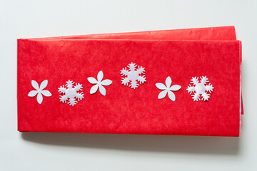 red tissue paper with fabric hearts and paper flowers