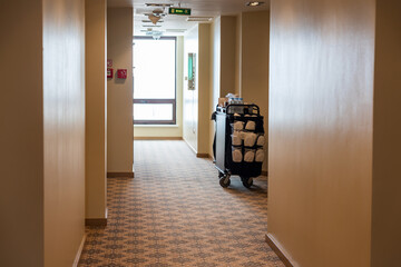 Empty hotel corridor with maid cart for room service