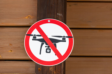 Drone flights prohibited sign on wooden wall background