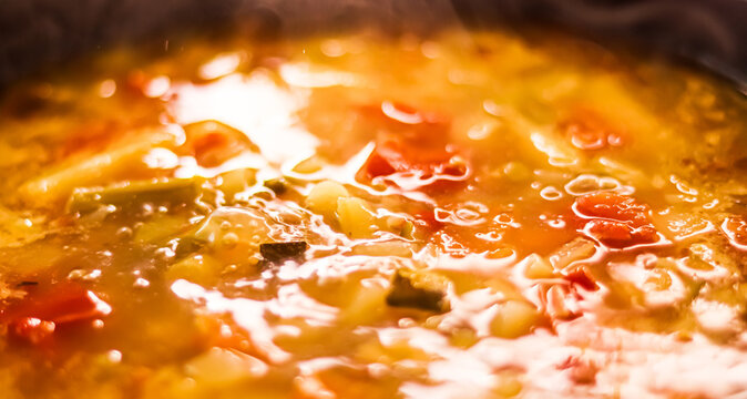 Cooking vegetable soup in saucepan, comfort food and homemade meal concept