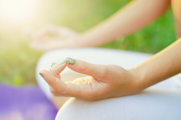 Young woman doing yoga exercise and meditation in the summer nature