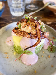 Grilled octopus with polenta and yogurt at a restaurant