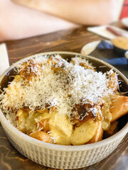 Batatas Bravas with peppers and parsley at a restaurant