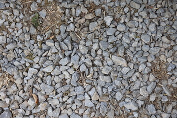 Gray gravel pattern, stone footpath closeup with dirt and textured stones