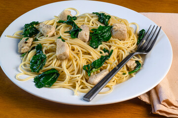 spaghetti top with sauteed spinach and chicken
