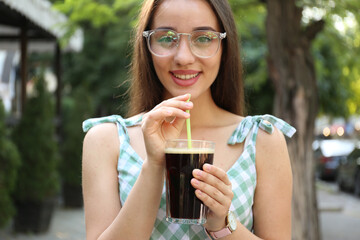 Young woman with cold kvass outdoors. Traditional Russian summer drink