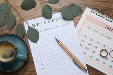 Flat lay composition with Wedding Checklist and calendar on wooden table