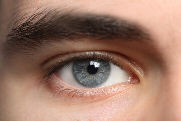 Closeup view of young man with beautiful grey eyes