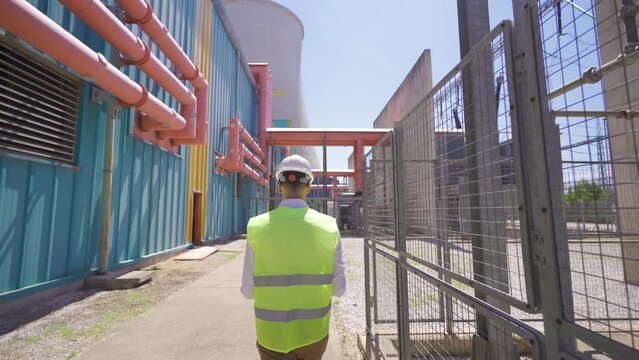 Engineer walking at nuclear power plant.
The engineer controlling the electrical transformers walks inside his power plant.

