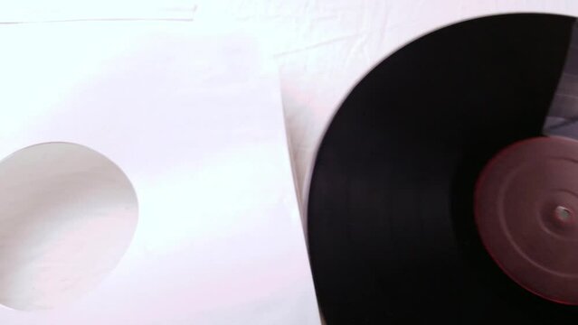 Pulling a record out of a white sleeve