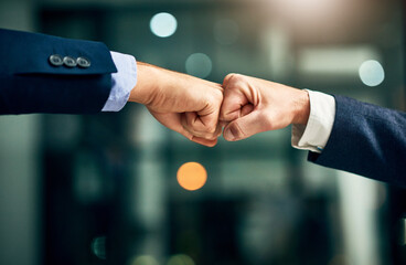 Partnership, teamwork and unity by hands fist bumping in support of a mission or goal. Business...
