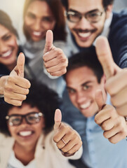 Fototapeta Thumbs up from a happy business team excited about the success they achieve together at work. Overhead view diverse group of corporate people excited by success and give approval to winning obraz