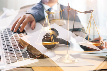 Male lawyer working with contract papers and wooden gavel on tabel in courtroom. justice and law ,attorney, court judge, concept.