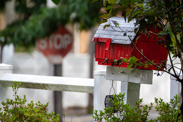 red mailbox on a fence