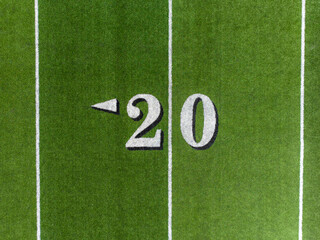 Aerial image of a typical synthetic turf football field 20 yard line in white. 	