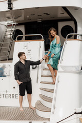 elegant couple on yacht. Man and woman in dress