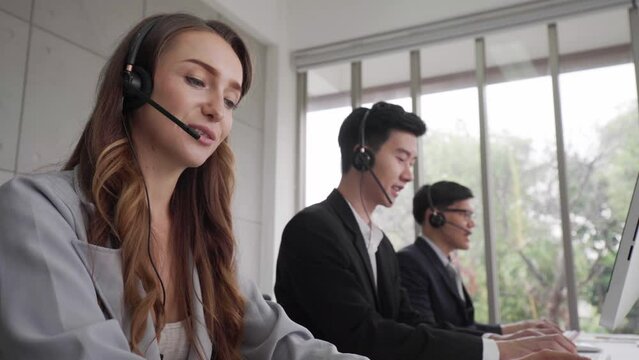 Busines man and woman callcenter team office working with laptop and earphone telesale and call center helpline concept