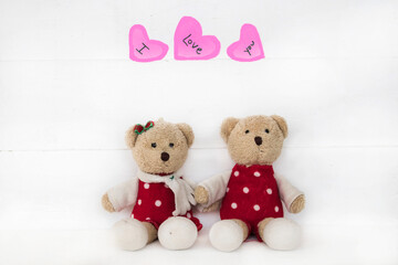 i love you message card handwriting on pink heart with couple teddy bear arrangement flat lay postcard style on background white 